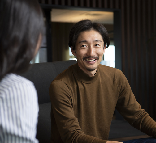 An RGF Staffing employee smiling at his colleague in the office